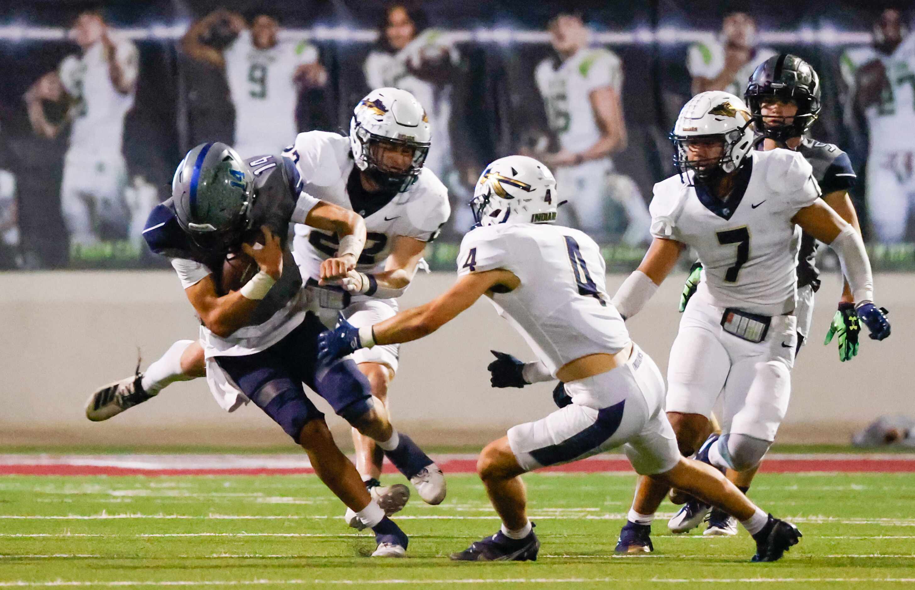 V.R. Eaton High School quarterback Noah Lugo (14) is tackled by Keller High School defense...