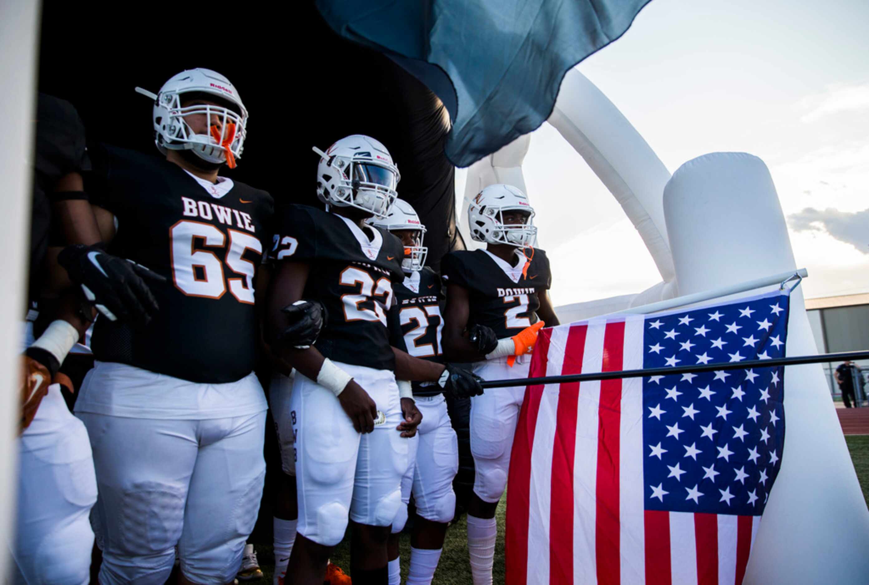 Arlington Bowie football players wait to enter the field before a high school football game...