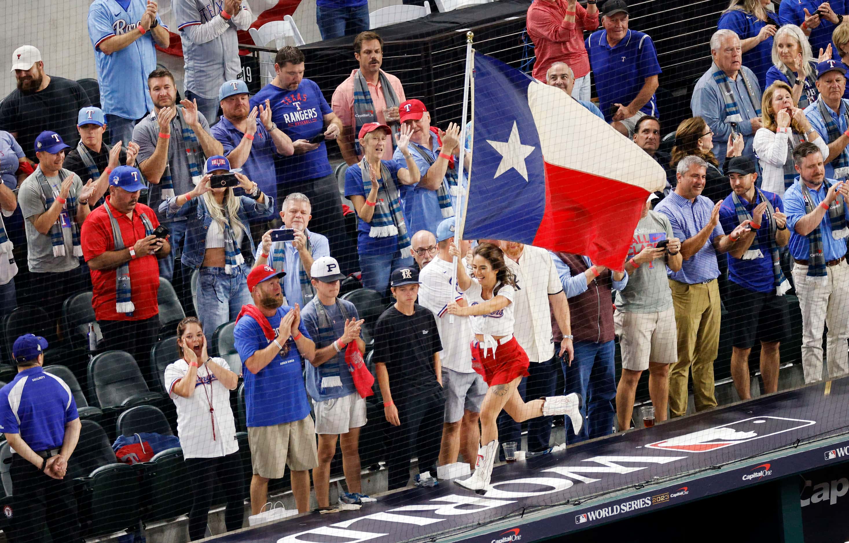 People cheer before the first inning in Game 1 of the World Series between the Texas Rangers...