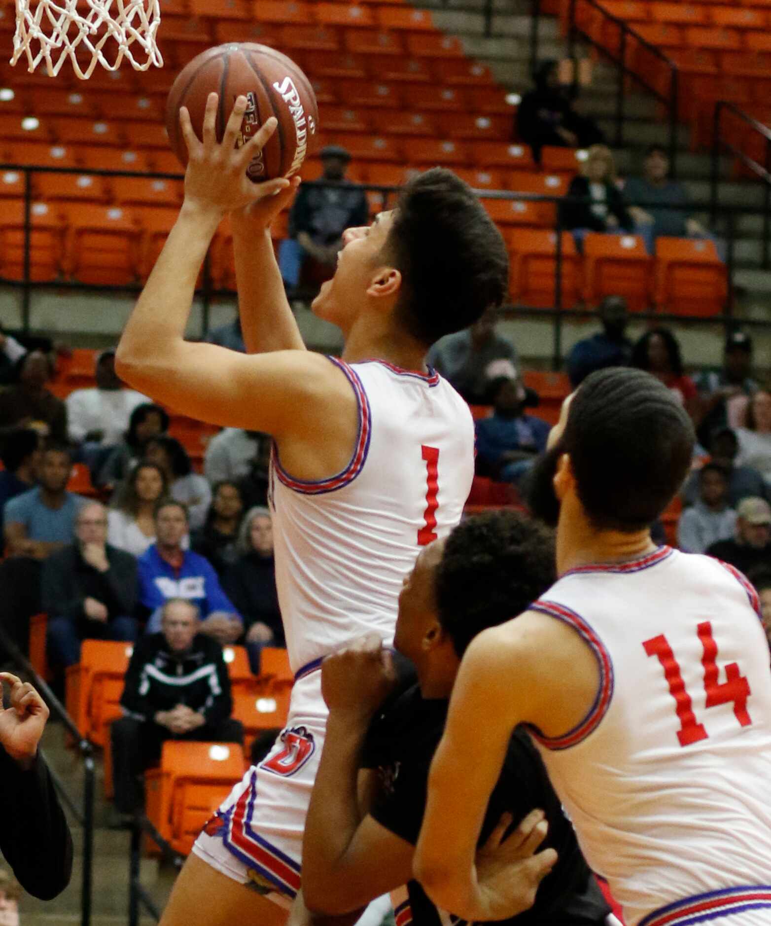 Duncanville guard Juan Reyna (1) cuts to the basket for two of his first half points during...