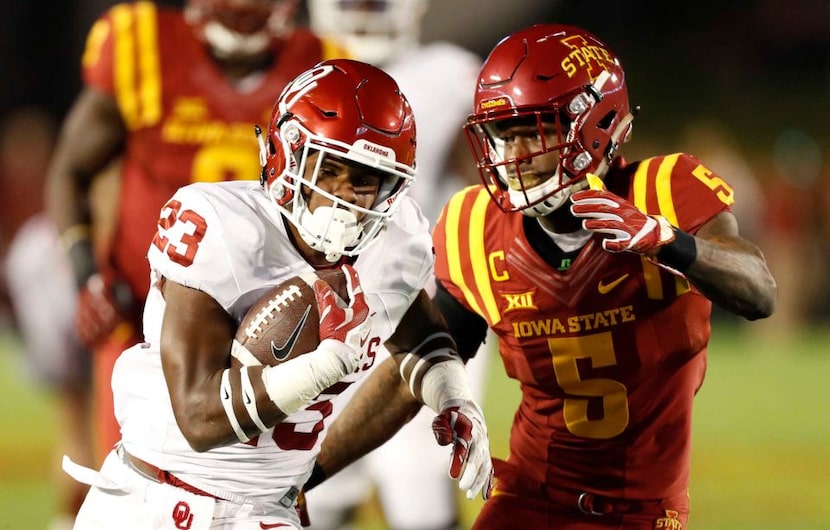 Oklahoma running back Abdul Adams (23) runs from Iowa State defensive back Kamari...