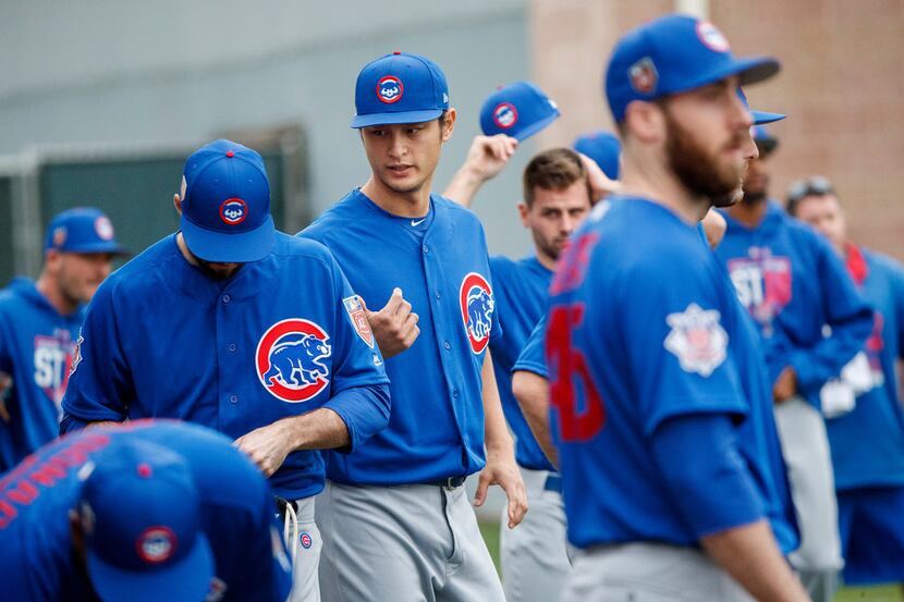 Chicago Cubs pitcher Yu Darvish talks with other players during the first day of pitchers...
