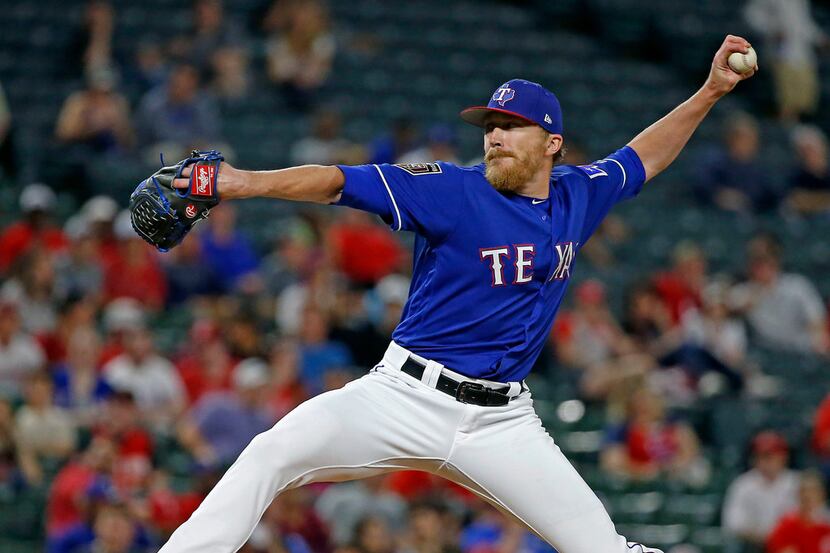 Texas Rangers relief pitcher Jake Diekman throws a pitch against Cincinnati Reds during the...