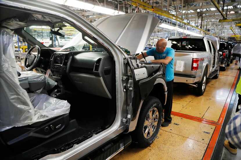 A United Auto Workers assemblyman works on a 2018 Ford F-150 truck being assembled at the...