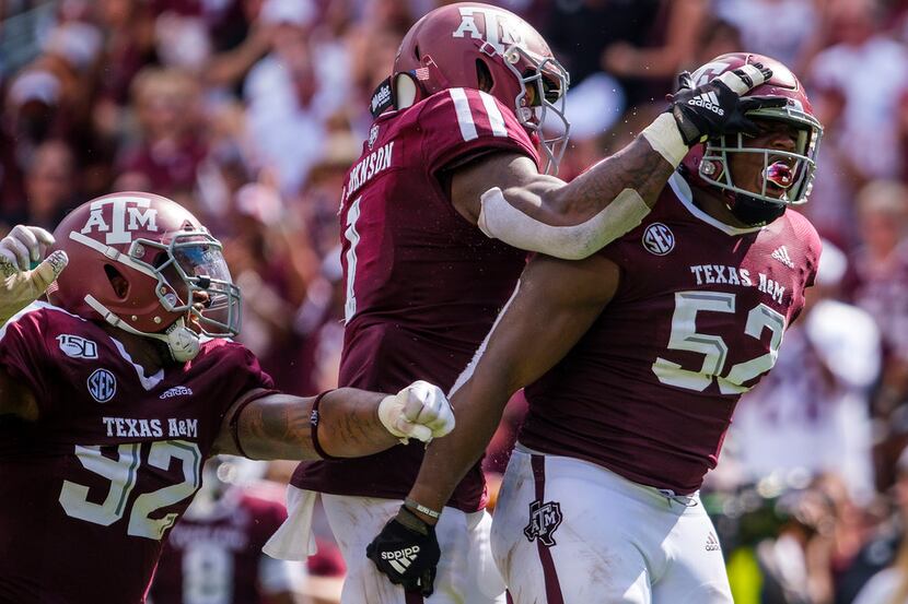 FILE - Texas A&M defensive lineman Justin Madubuike (52) celebrates with Buddy Johnson (1)...
