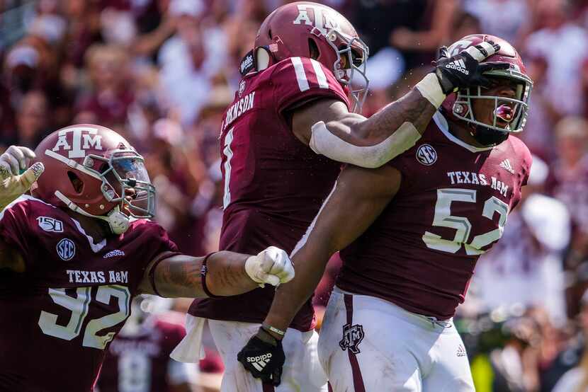 FILE - Texas A&M defensive lineman Justin Madubuike (52) celebrates with linebacker Buddy...