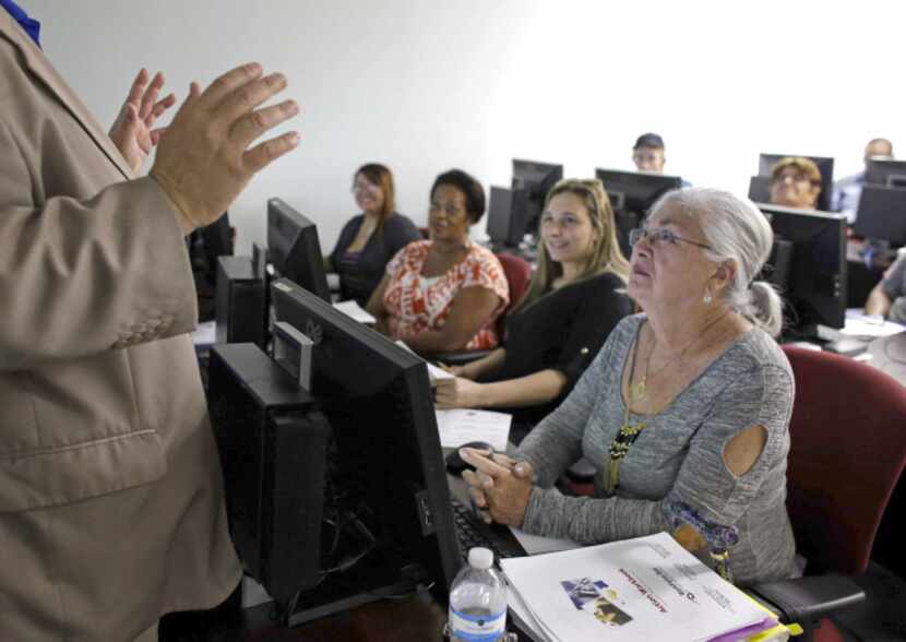 Rosi Pozzi, 73, listens raptly during a job search seminar in Davie, Fla. Despite steady...