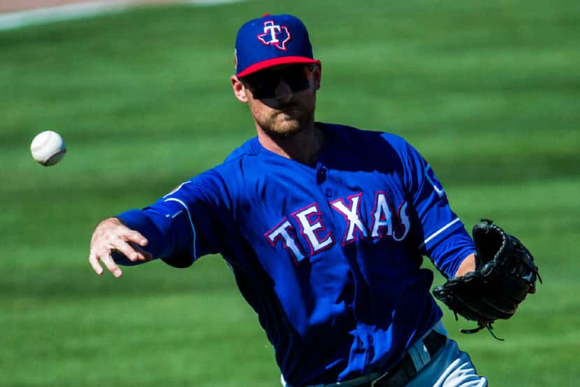 Texas Rangers third baseman Will Middlebrooks (15) throws to first base during the third...