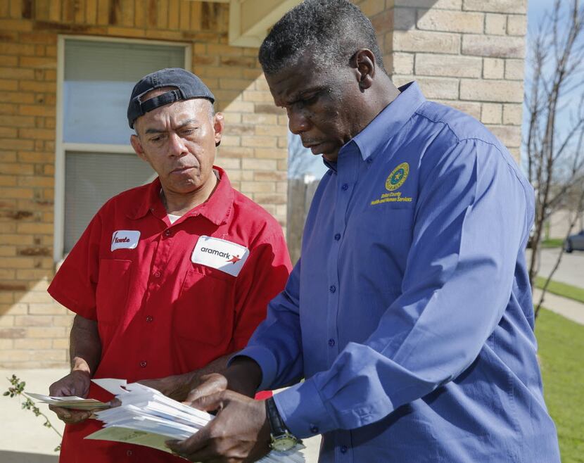 West Dallas resident Vincente Soto, left, listens to Dallas County Health and Human Services...