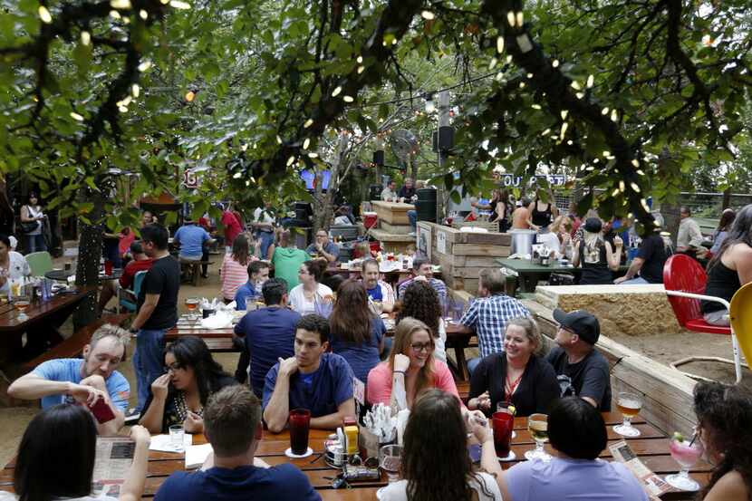 Groups enjoy the early evening on the patio at the Katy Trail Ice House Outpost.