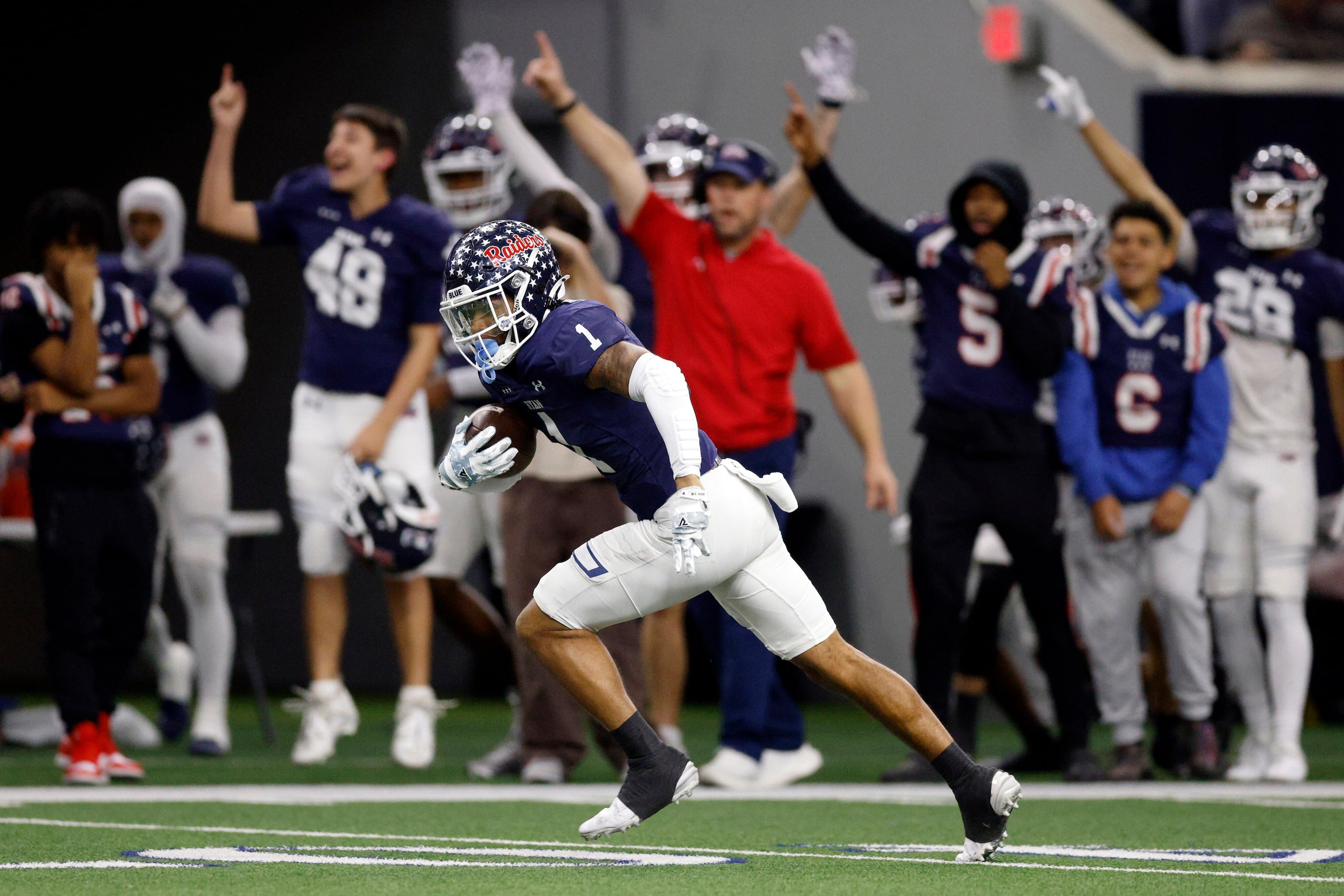 Denton Ryan defensive back Trae Williams (1) returns an interception for a touchdown during...