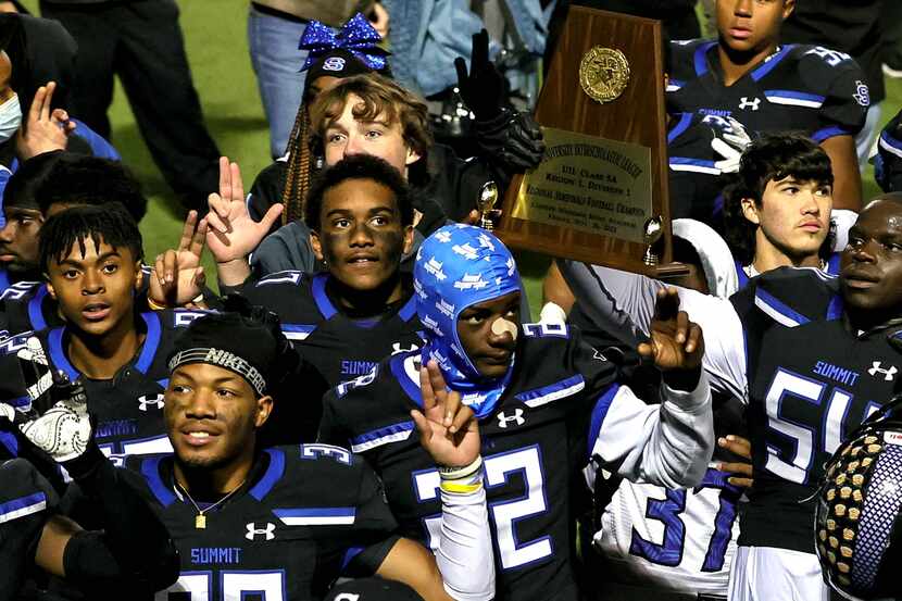 Mansfield Summit holds up their trophy after beating Midlothian, 28-20 in the 5A Division I...