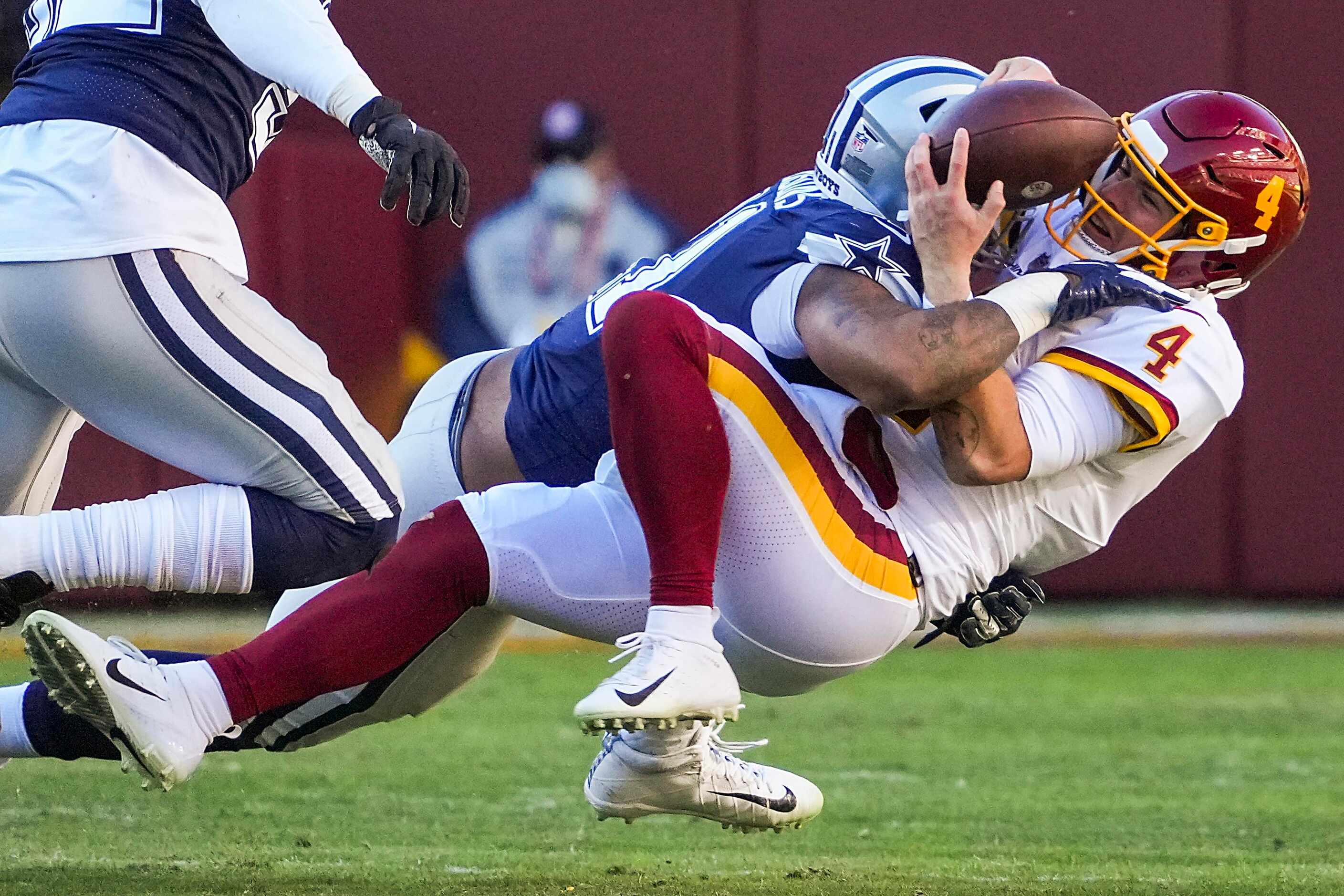 Washington Football Team quarterback Taylor Heinicke (4) fumbles as he is sacked by Dallas...