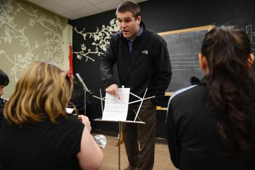 Josh Knapp, a volunteer and Irving school teacher, guides the beginning band class at the...