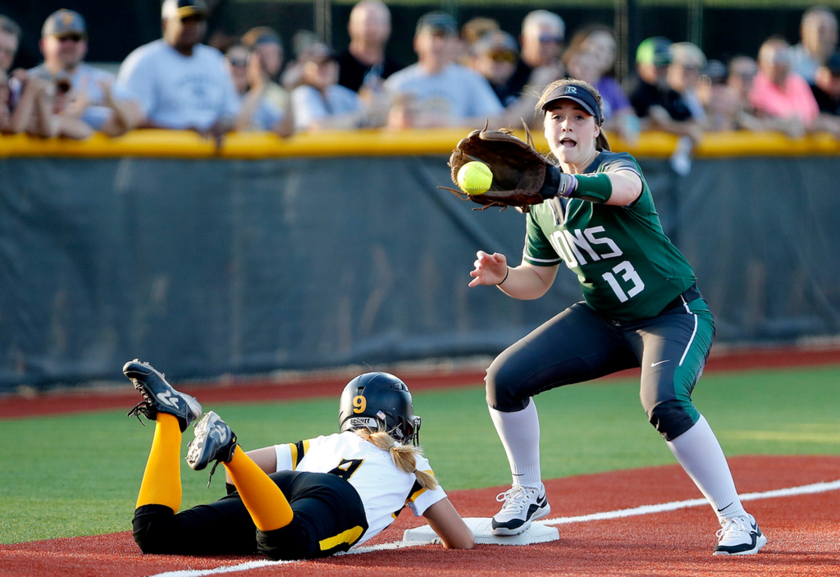 Forney High School outfielder Hannah Holdbrook (9) slides safely into third base on a pick...