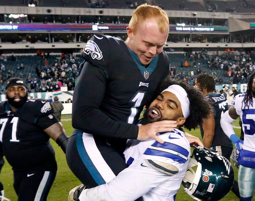 FILE - Dallas Cowboys running back Ezekiel Elliott (21) picks up Philadelphia Eagles punter...