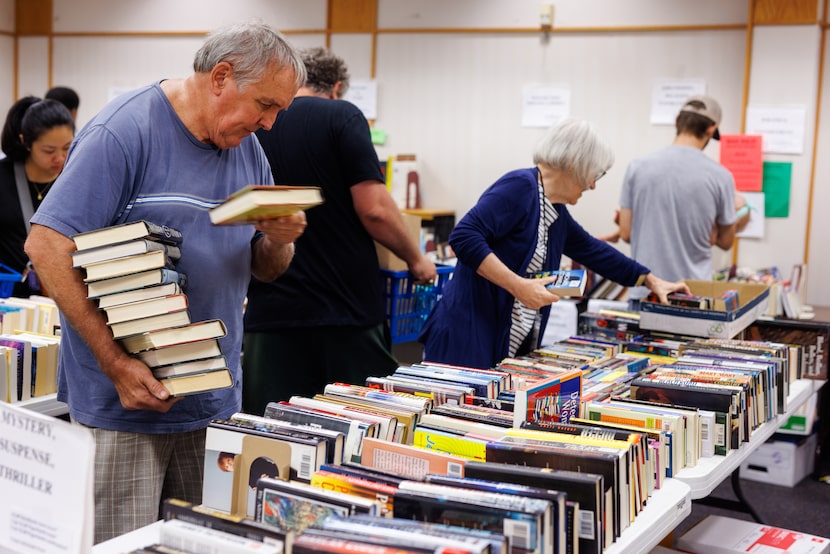 Mike Clem with Skillman Southwestern Library Friends gathers books for sale along with Ruth...