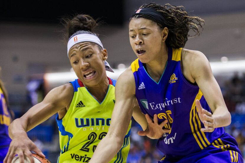 Dallas Wings forward Aerial Powers (23) keeps the ball away from Los Angeles Sparks guard...
