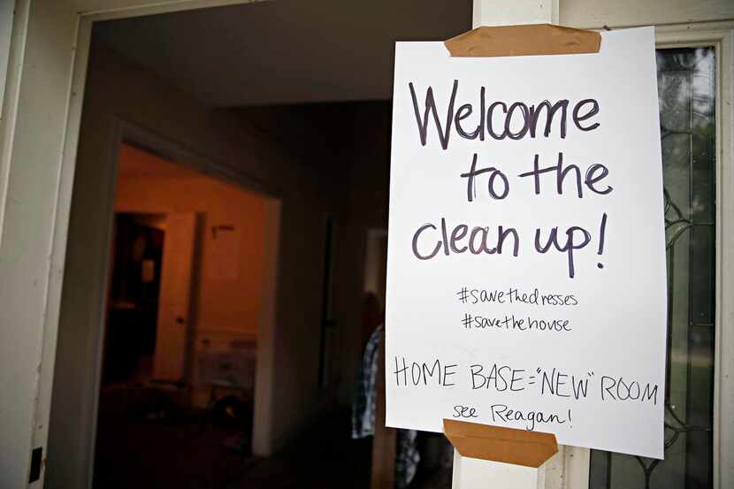 
A sign greets volunteers helping clean up one of several Garland homes damaged by an...