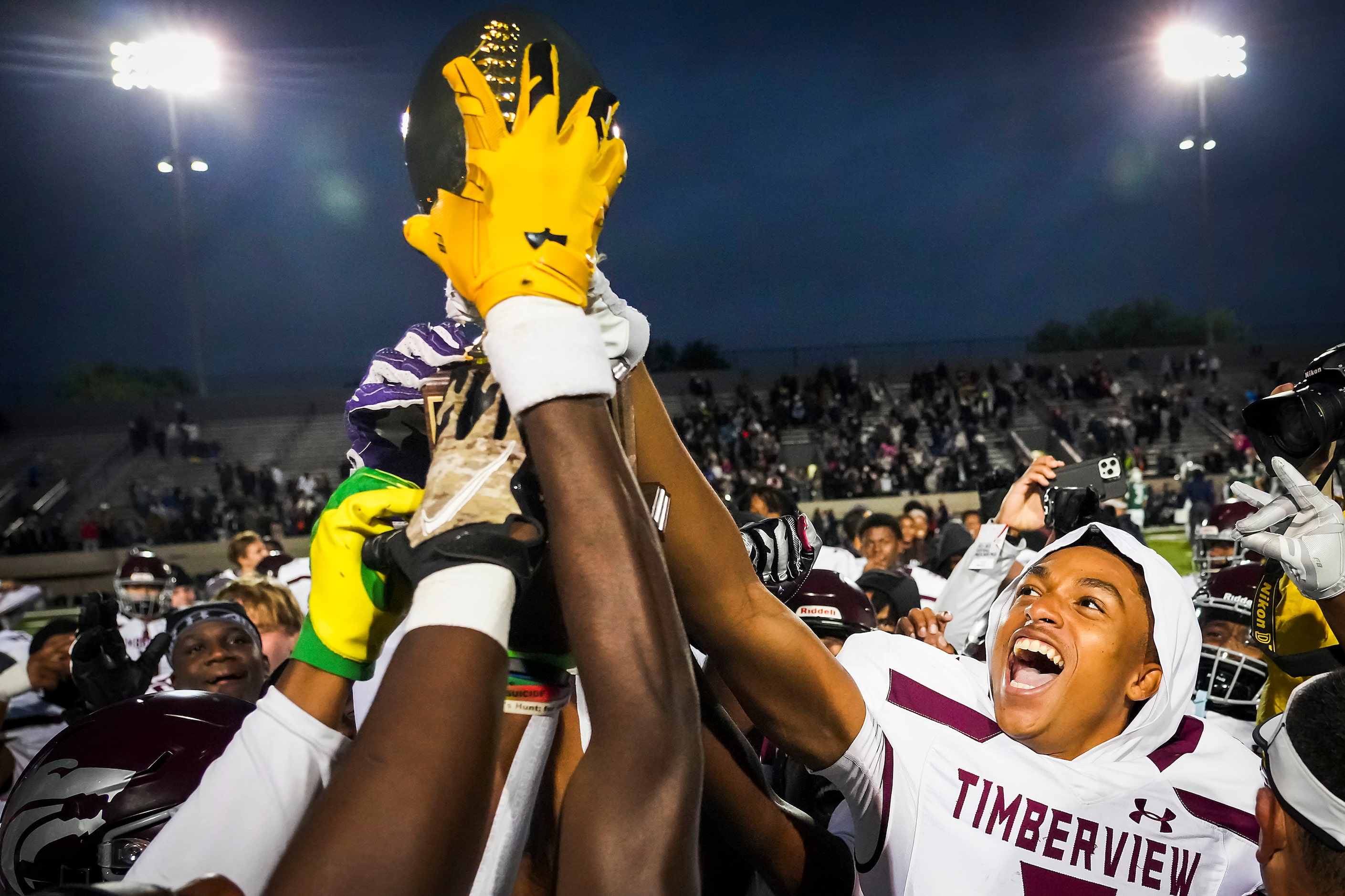 Mansfield Timberview players, including defensive back Jordan Sanford (right) celebrate with...