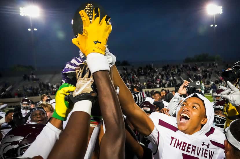 Mansfield Timberview players, including defensive back Jordan Sanford (right) celebrate with...