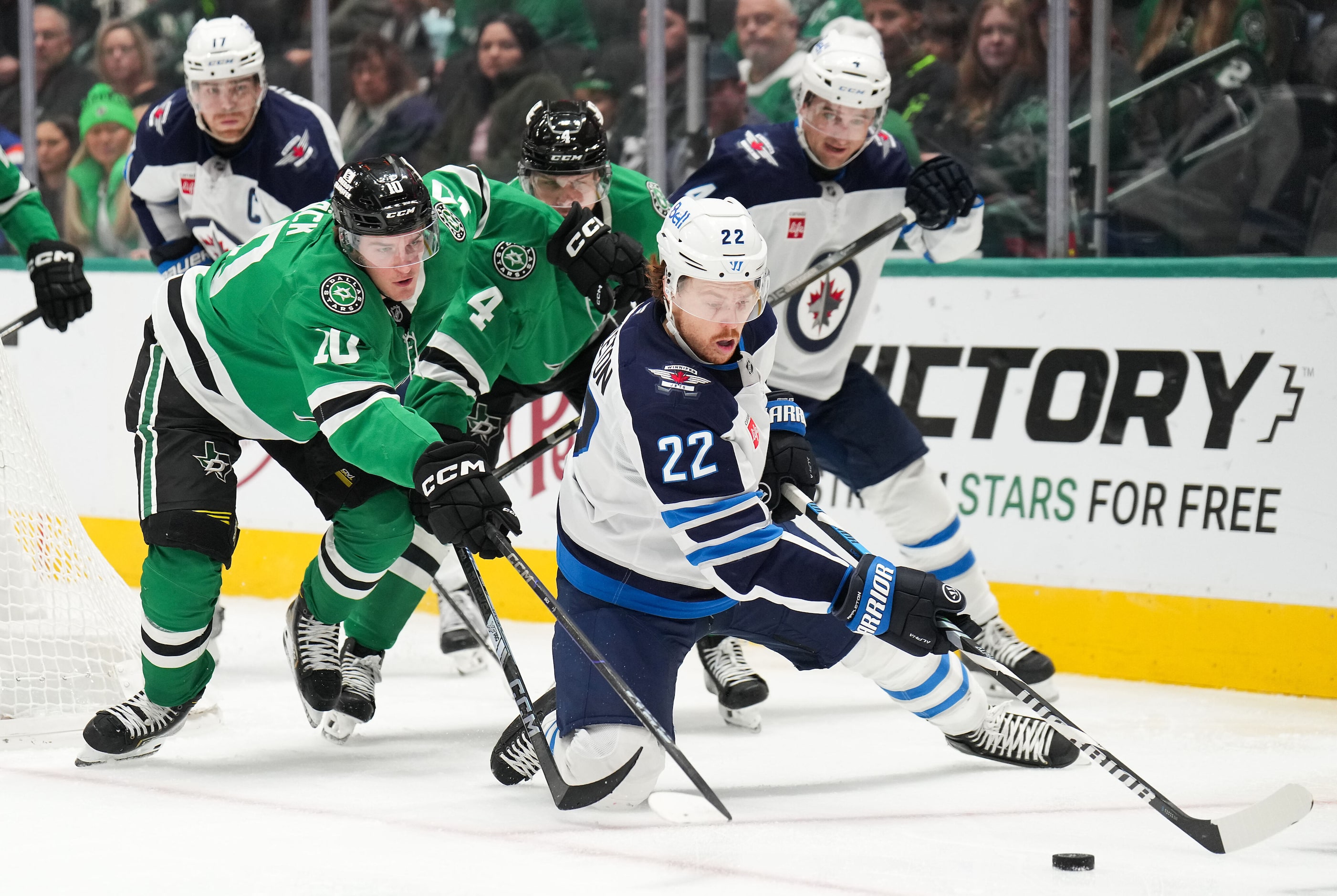 Dallas Stars center Oskar Bäck (10) fights for the puck against Winnipeg Jets center Mason...