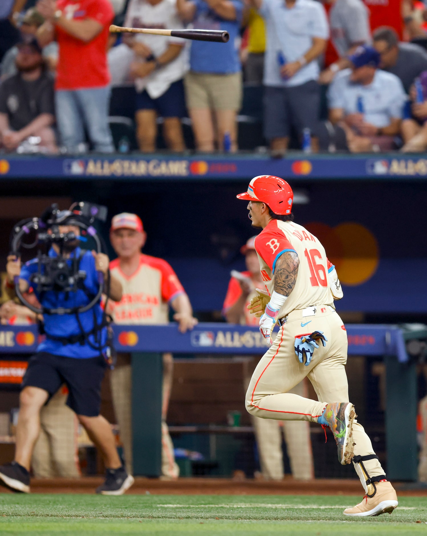 American League's Jarren Duran, of the Boston Red Sox, tosses his bat after hitting a...