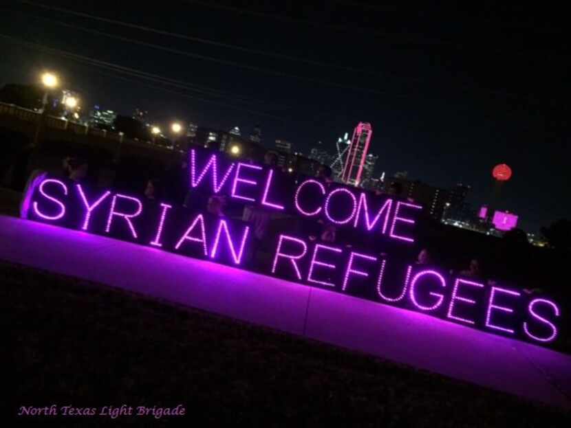 The North Texas Light Brigade has projected signs that display a variety of social-justice...