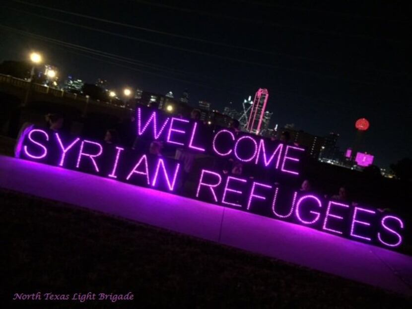 The North Texas Light Brigade has projected signs that display a variety of social-justice...