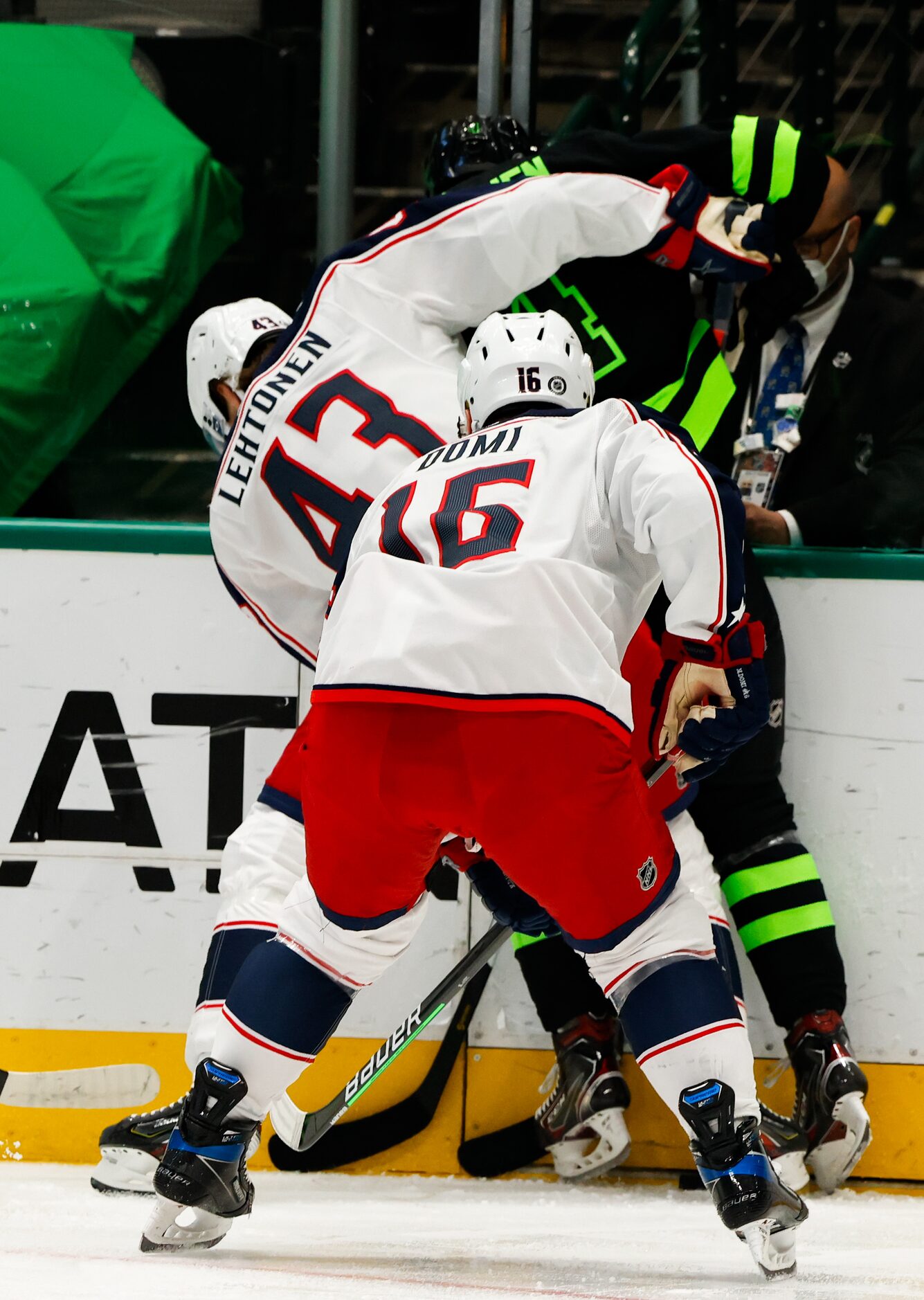 Dallas Stars defenseman Miro Heiskanen (4) is pinned against the wall by Columbus Blue...