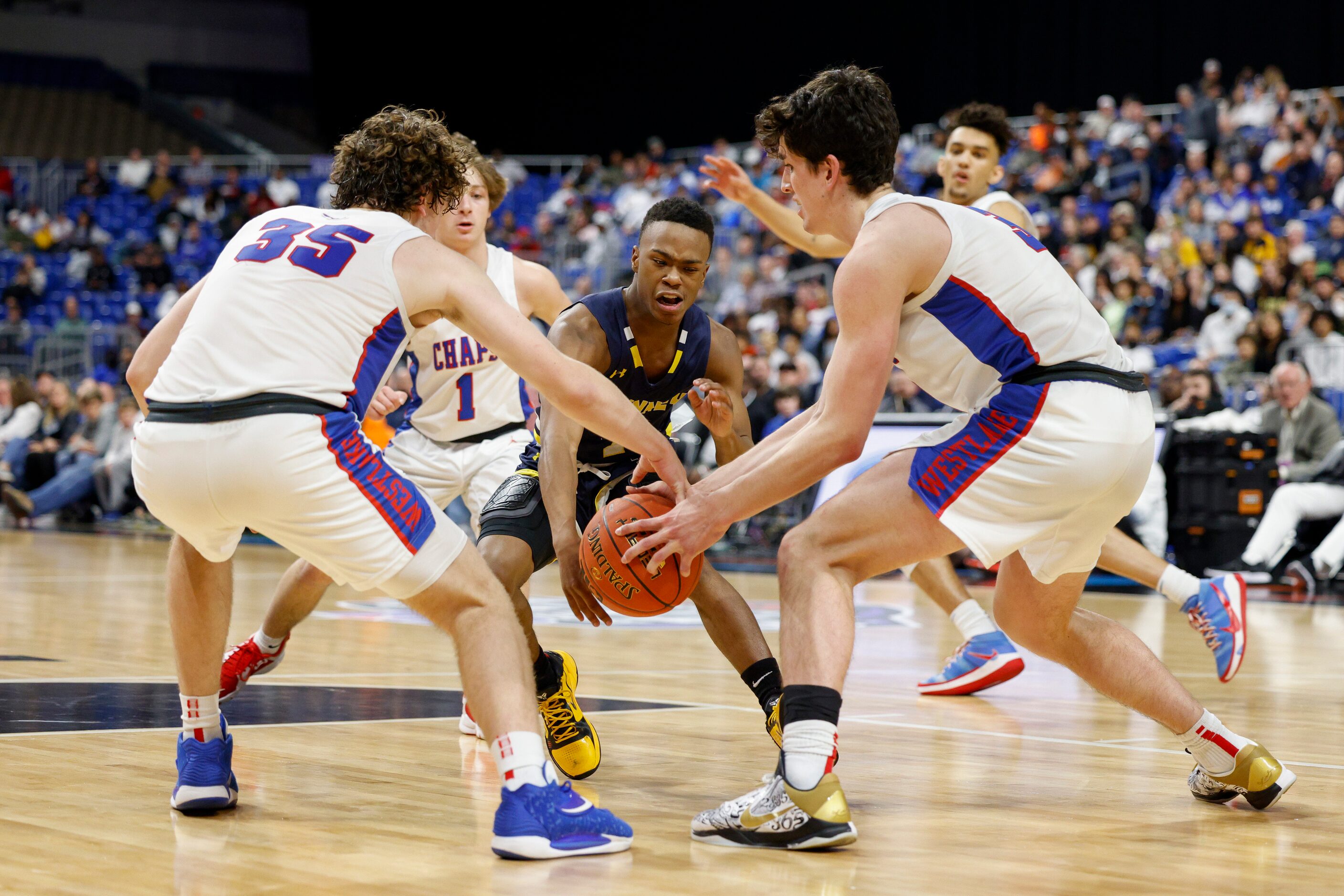 McKinney guard Jacovey Campbell (3) loses the ball as he meets Austin Westlake guard Conor...