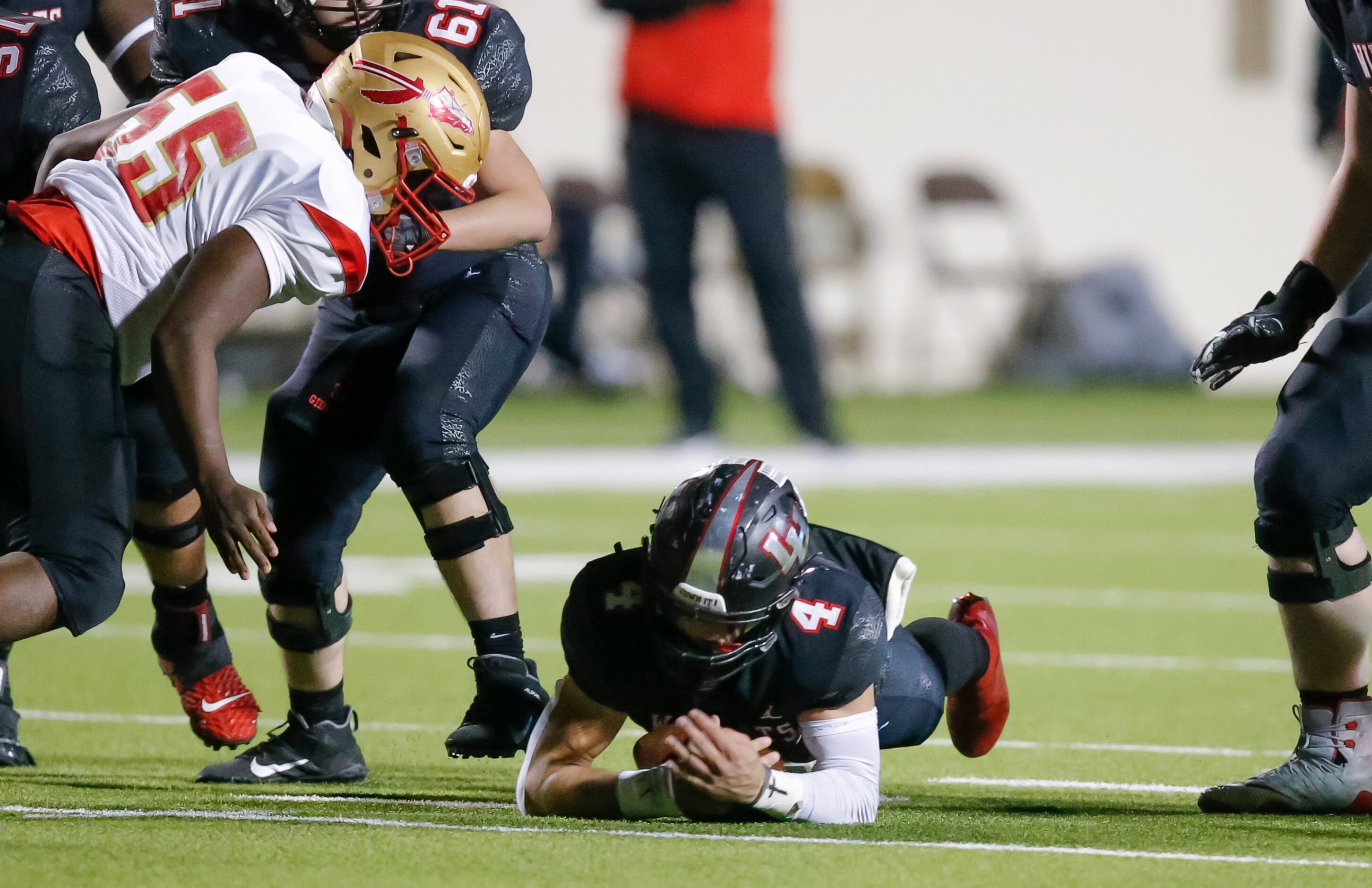 Lake Highlands senior quarterback Caden Dotson (4) falls onto his own fumble during the...