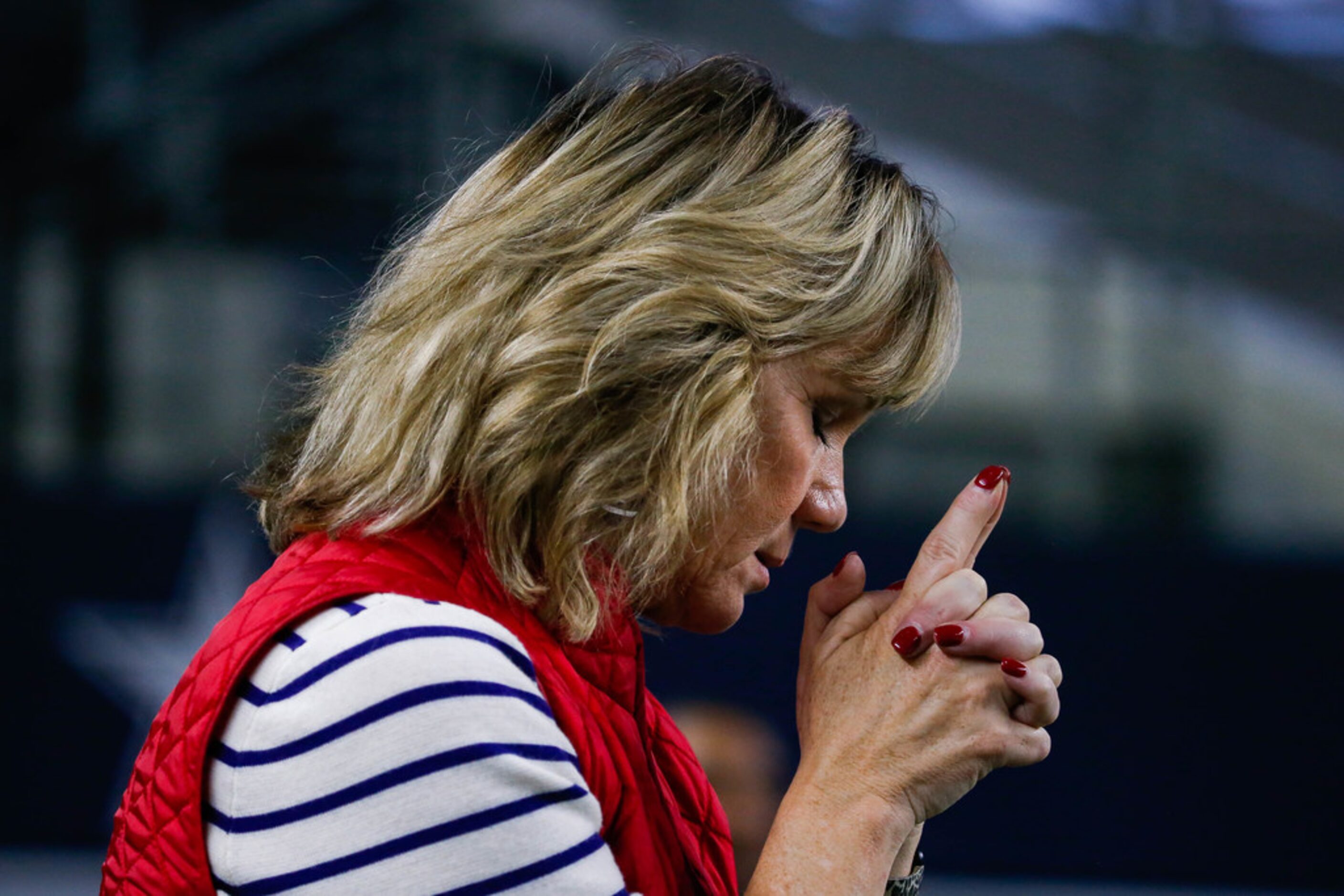 Debbie Lokey, Denton Ryan's assistant coach Tyler Lokey's mother, prays in the final seconds...