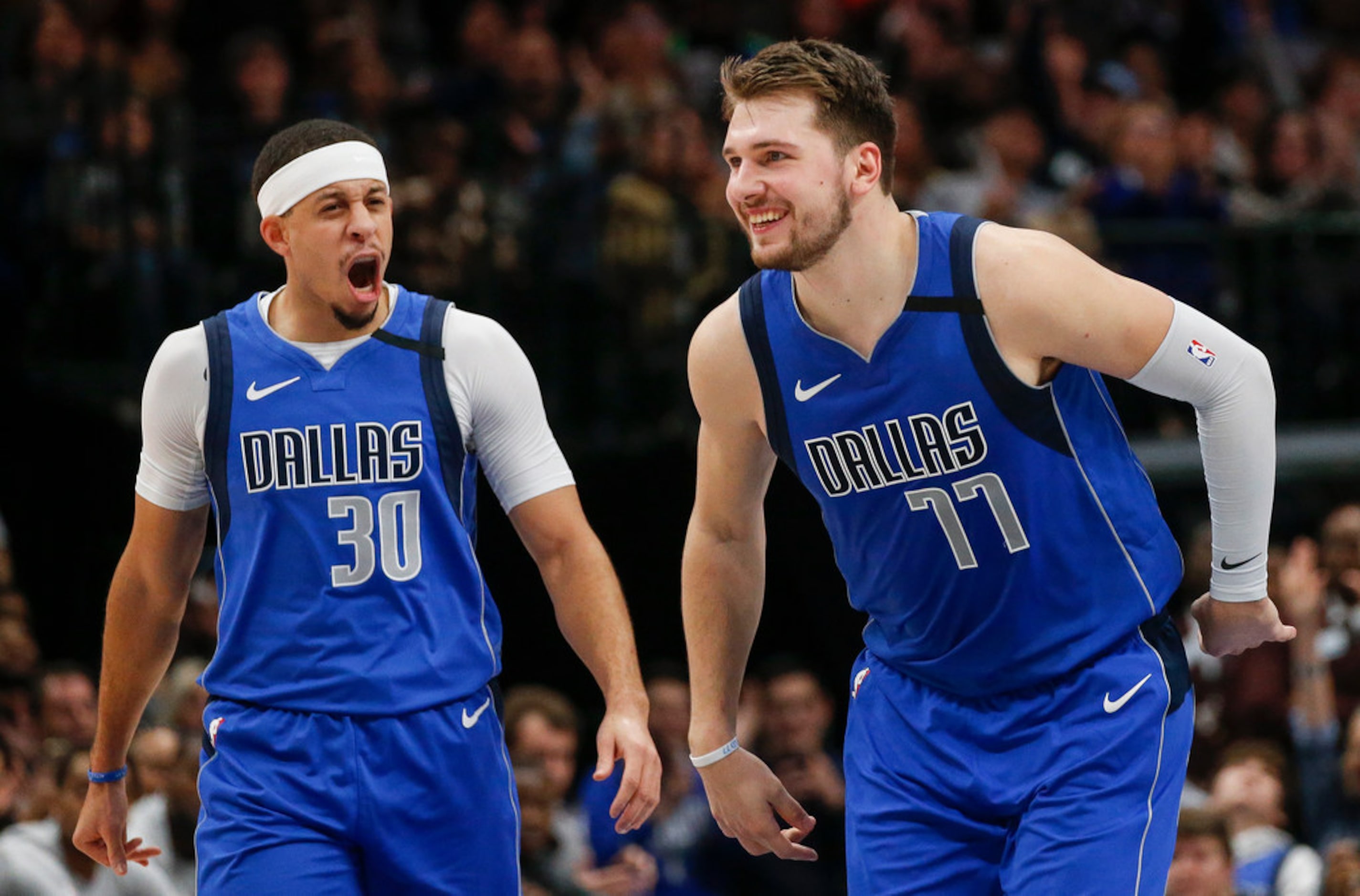 Dallas Mavericks forward Luka Doncic (77) celebrates scoring alongside guard Seth Curry (30)...