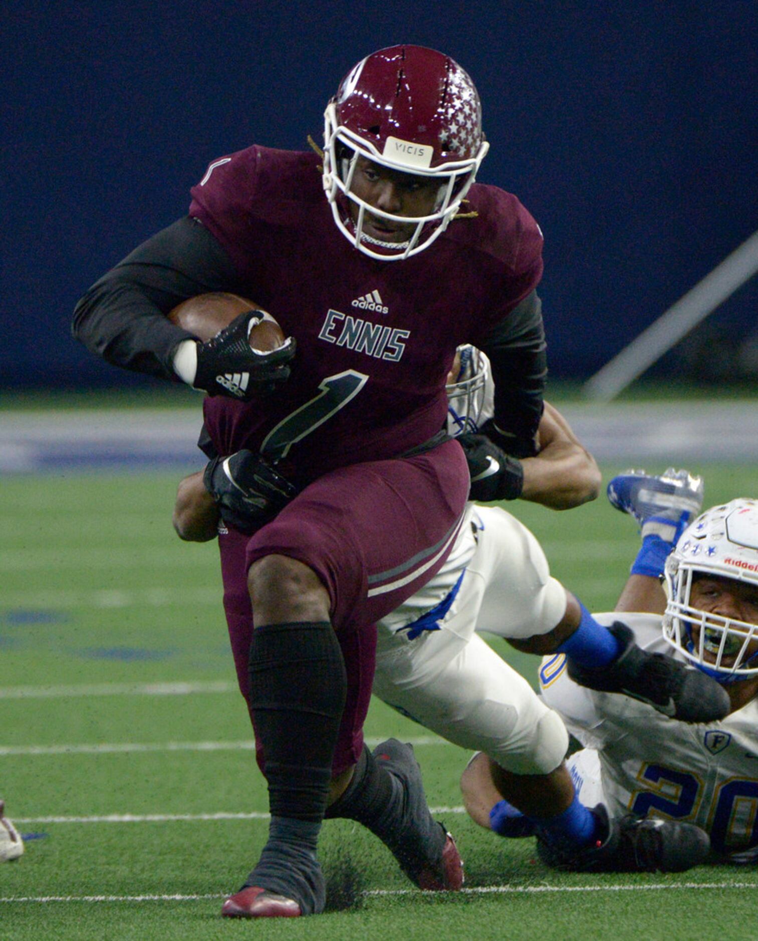 Ennis' Jarius Jones (1) tries to run through a tackle by Frisco's Aaron Taylor in the first...