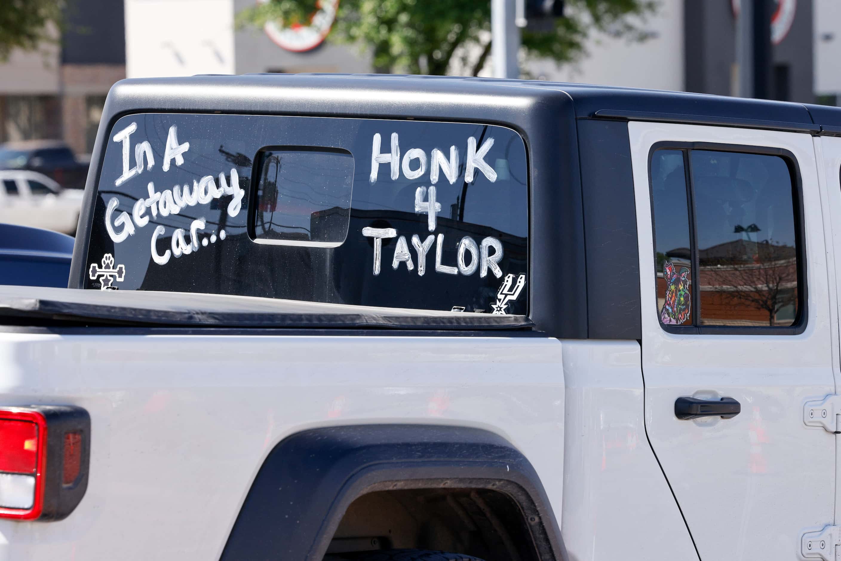 A Jeep drives along Collins Street with words inspired by Taylor Swift’s “Getaway Car”...