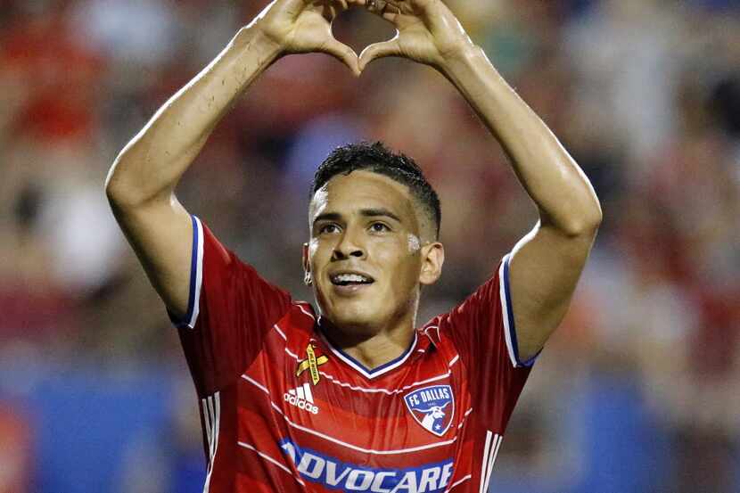 FC Dallas midfielder Victor Ulloa (8) flashes a heart shape with his hands to the fans after...