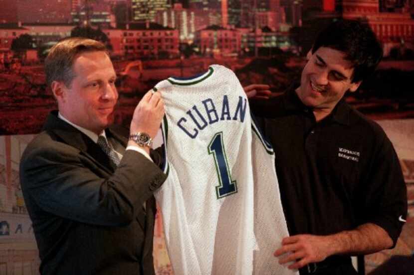 Ross Perot Jr. (left) presents Mark Cuban with a Dallas Mavericks jersey Thursday, January...