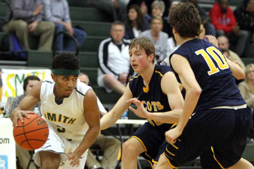 Carrollton Newman Smith's Darion Brown (5) eyes an open lane as he is defended By highland...