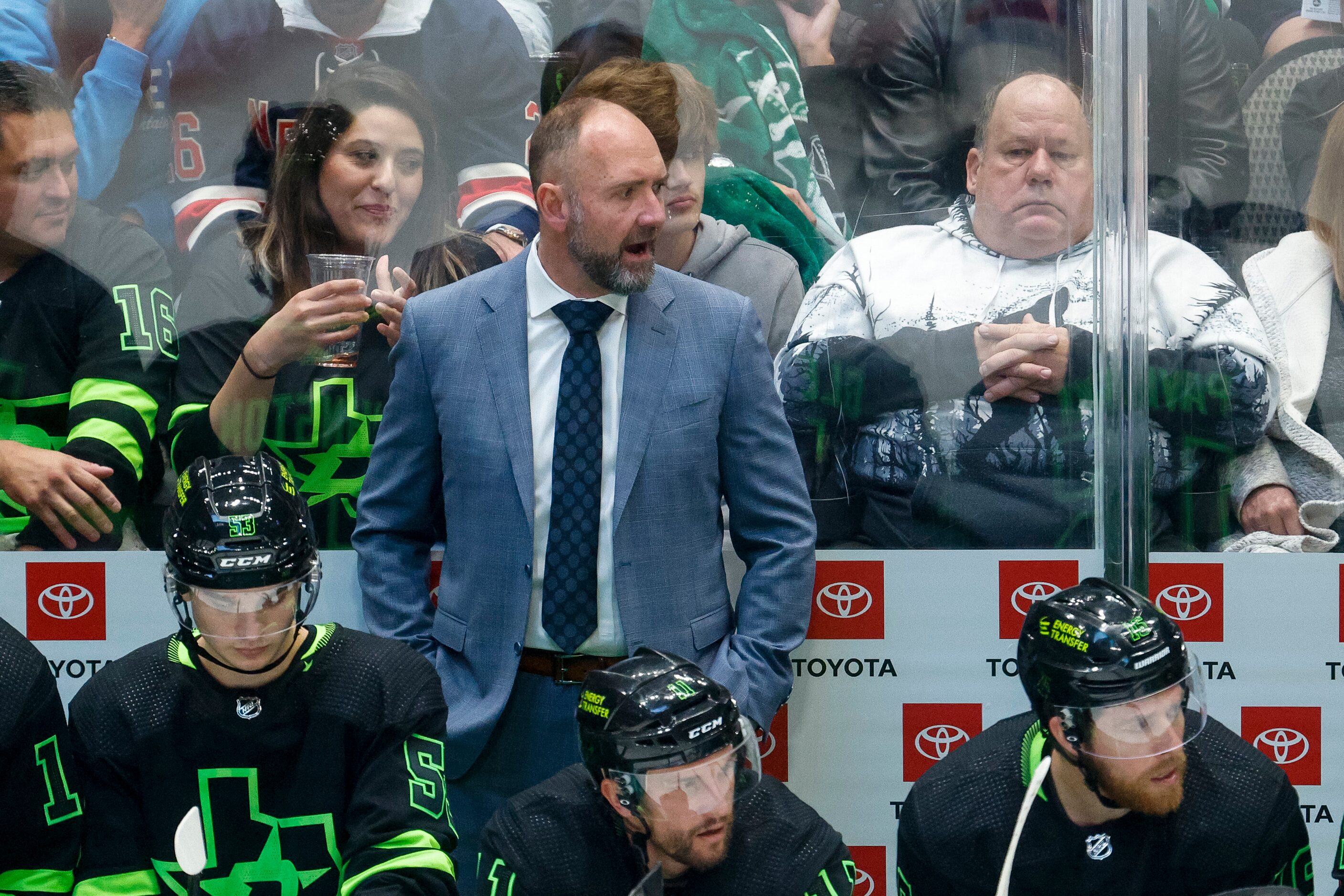 Dallas Stars head coach Peter DeBoer talks to his team on the bench during the second period...