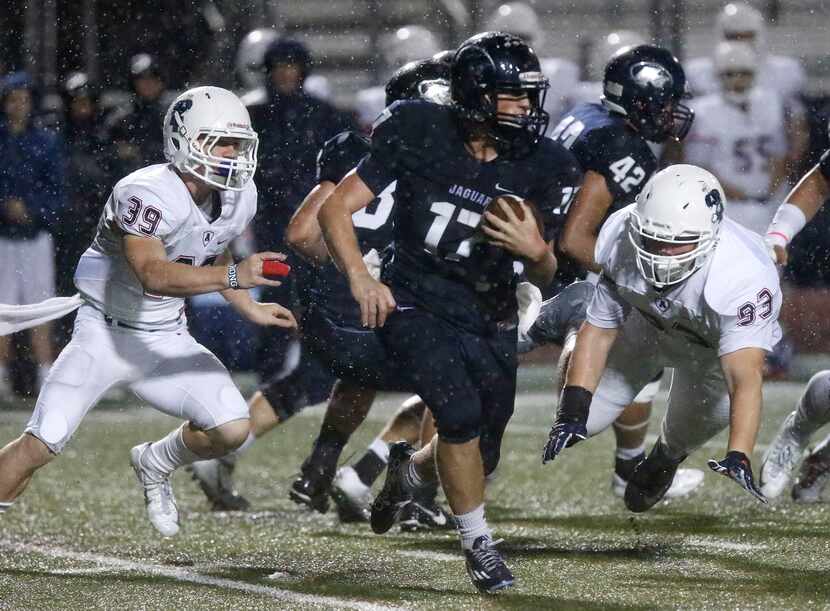Flower Mound quarterback Noble Newton carried the football between Allen defenders Dallas...