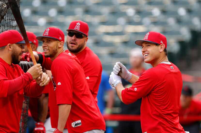 Former Texas Ranger and currsst Los Angeles Angel Ian Kinsler (right) jokes with catcher...