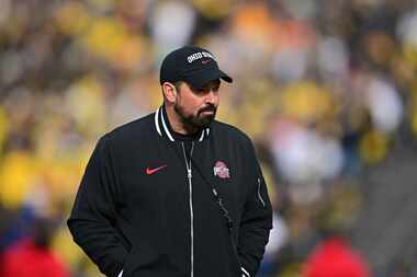 Ohio State head coach Ryan Day walks before a NCAA college football game against Michigan,...