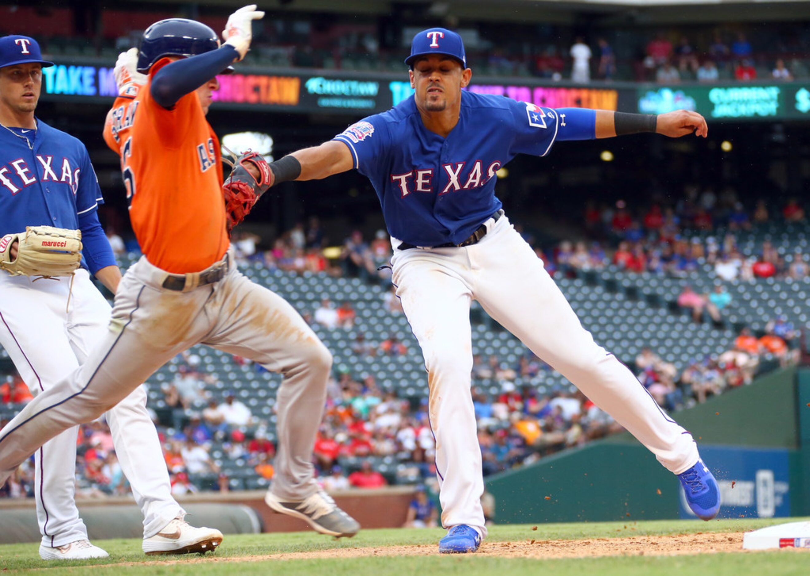 ARLINGTON, TX - JULY 14:  Ronald Guzman #11 of the Texas Rangers tags out Myles Straw #26 of...