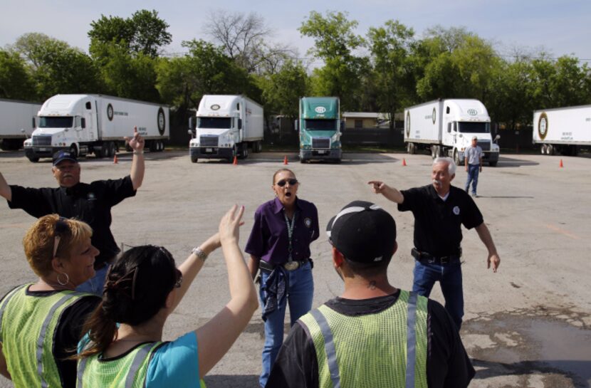 From left: Instructor David Ables, Connie Ward and director Greg Peace talk to students...