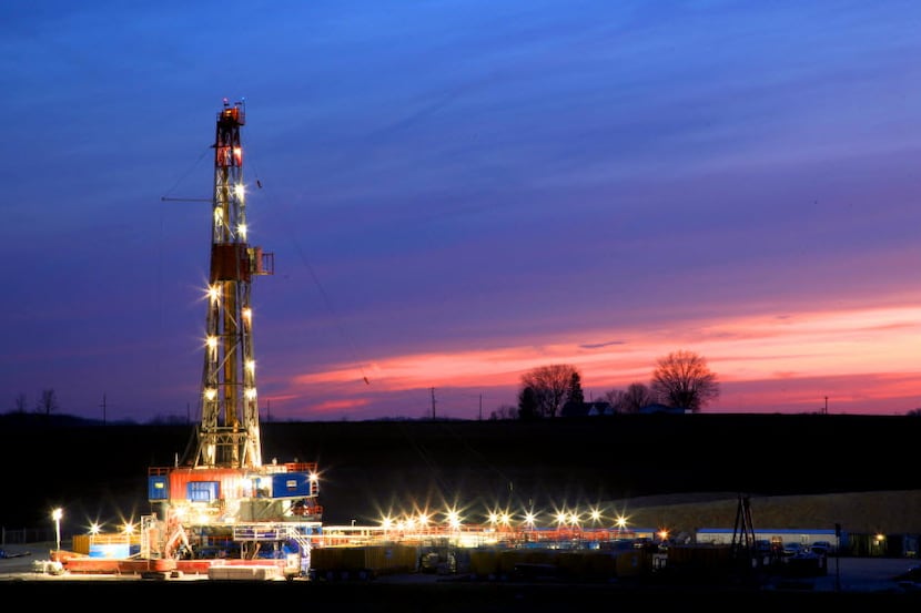 A Patterson-UTI rig (rig #328) stands lit in the waning light of day as it drills on the...