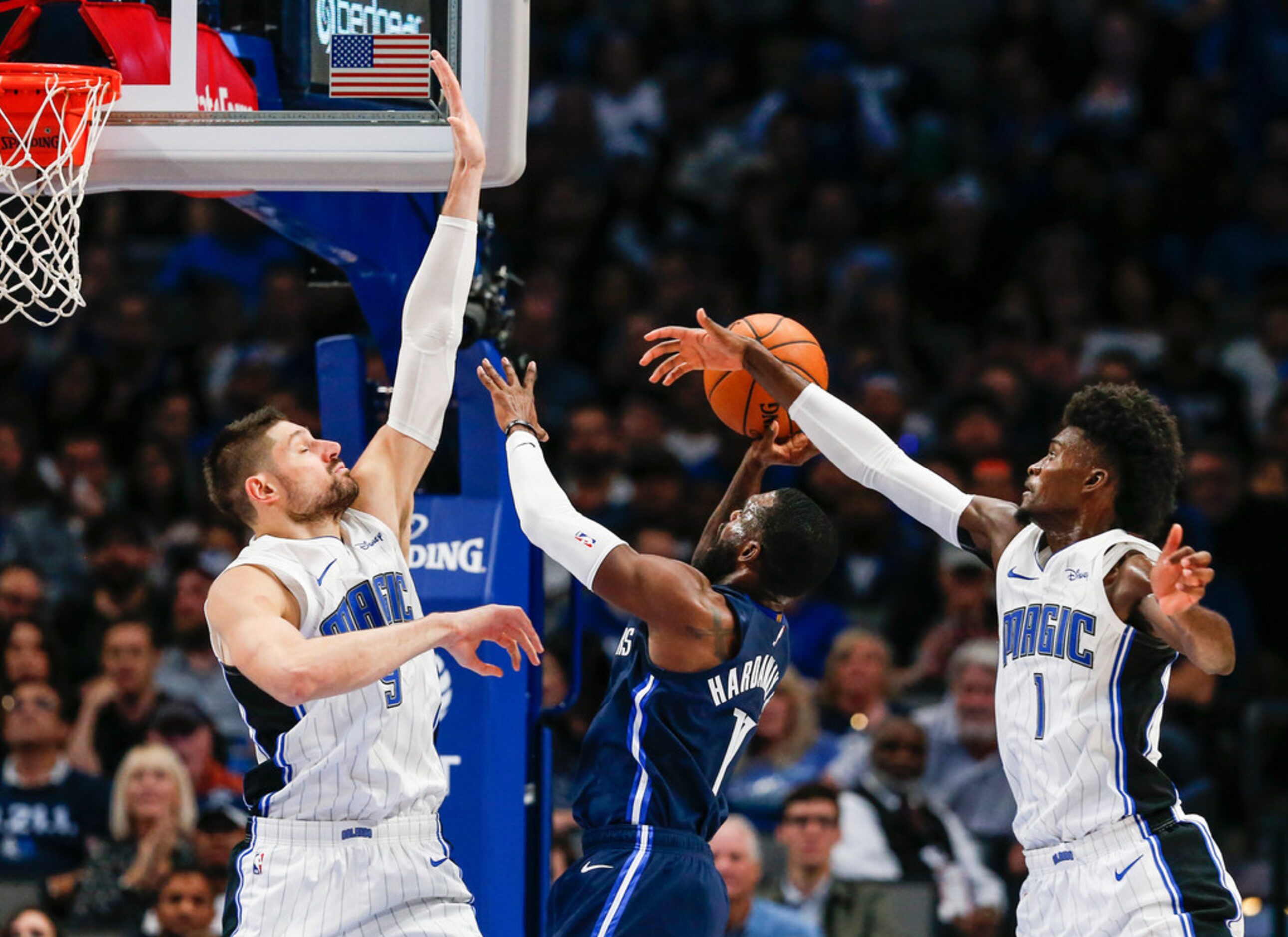 Dallas Mavericks guard Tim Hardaway Jr. (11) attempts a shot past Orlando Magic center...