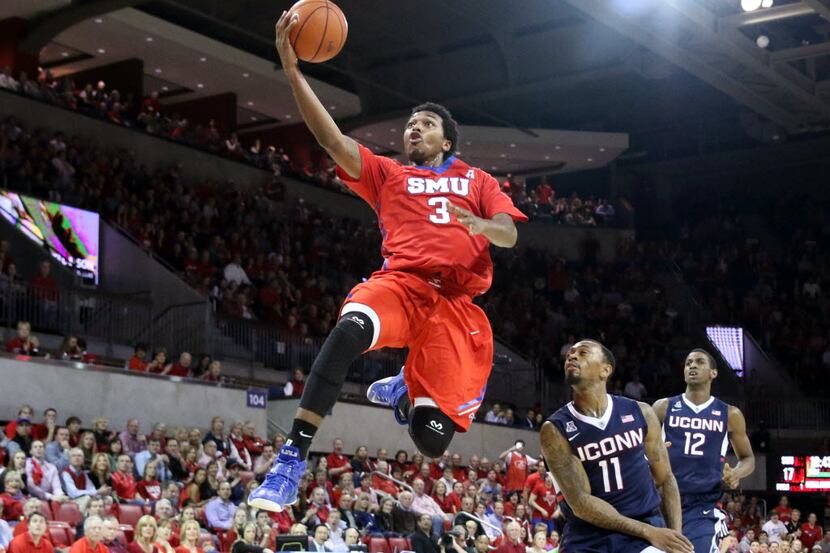 SMU guard Sterling Brown breaks away for a layup during the first half of an NCAA basketball...