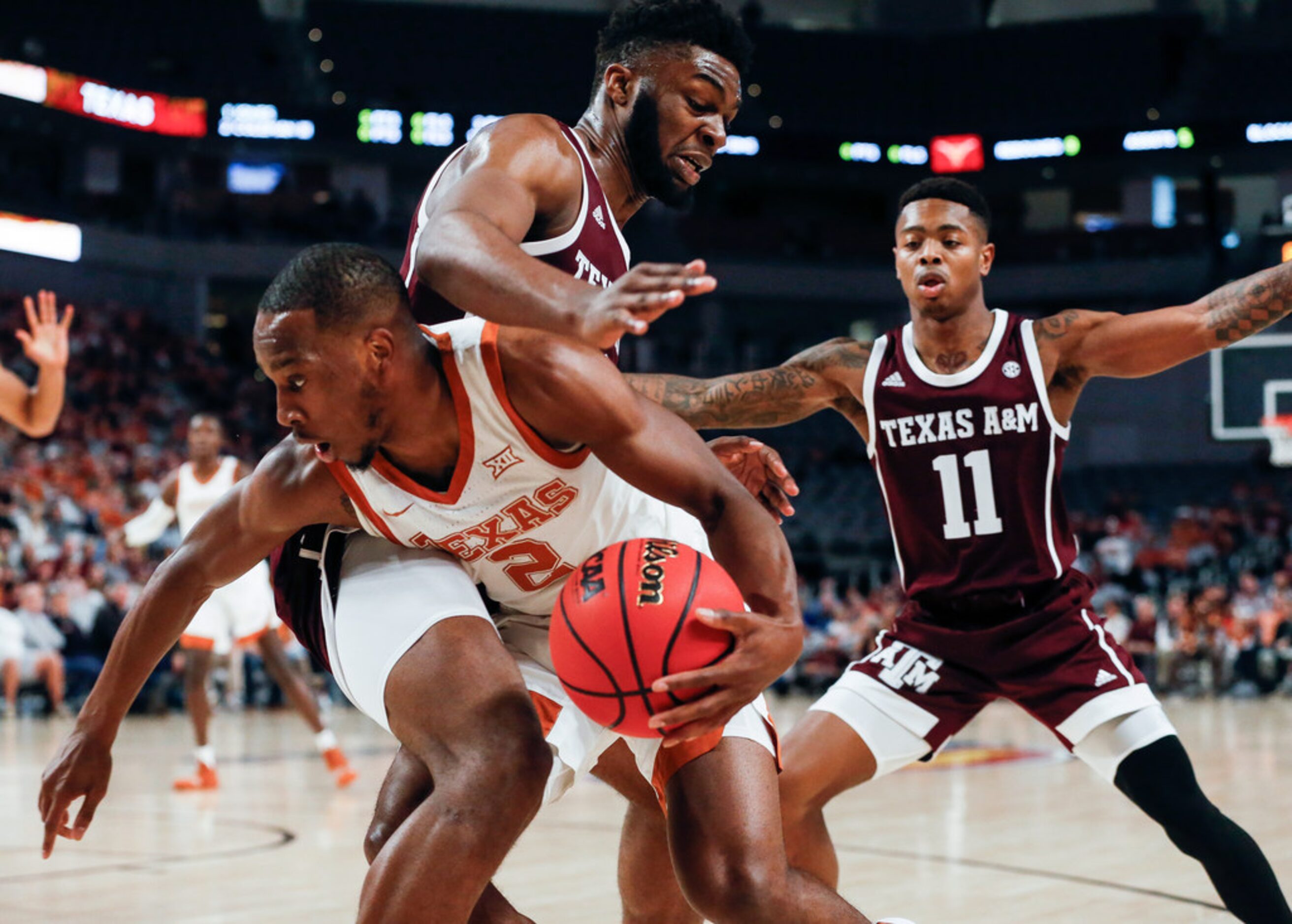 Texas Longhorns guard Matt Coleman III (2) drives past Texas A&M Aggies forward Josh Nebo...