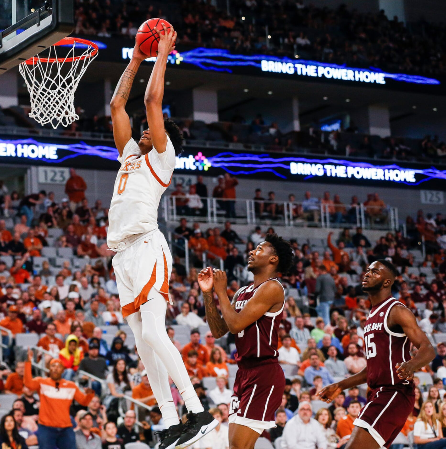 Texas Longhorns forward Gerald Liddell (0) dunks over Texas A&M Aggies guard Quenton Jackson...